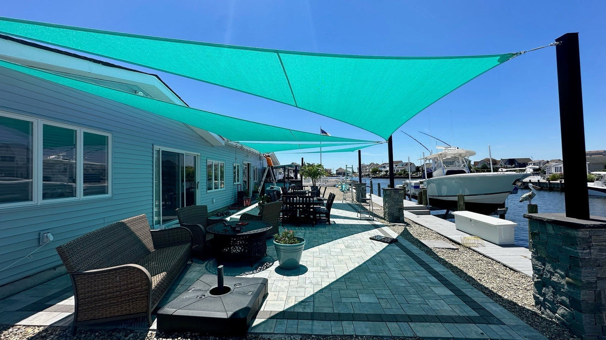 light blue waterproof shade sails canada at a boat launch providing shade and weather protection