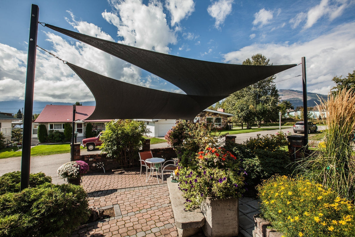 Shade Sail garden design on a property with vibrant green plants and a modern sail canopy on a sunny day.
