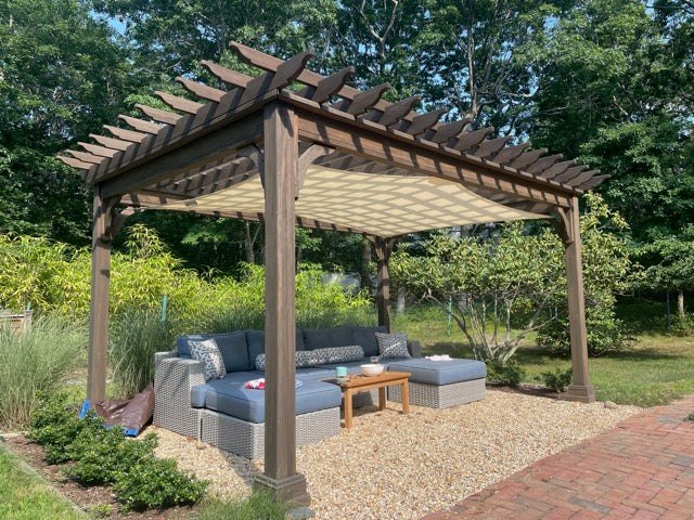 Modern backyard pergola setup featuring outdoor seating and shade, showcasing outdoor solutions landscaping design.