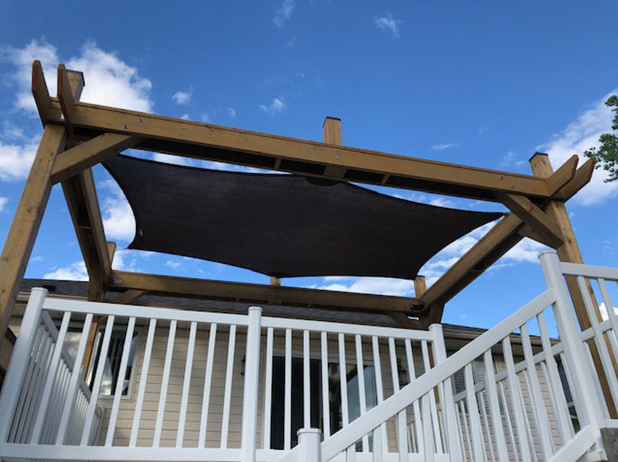 Black 6-Pointed Shade Sail attached to the deck of a house.